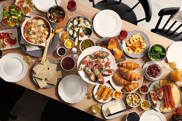 istock Brunch table setting with different delicious food and chairs indoors, top view 1453969556