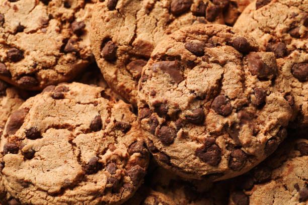 istock Many delicious chocolate chip cookies as background, closeup 1453969605