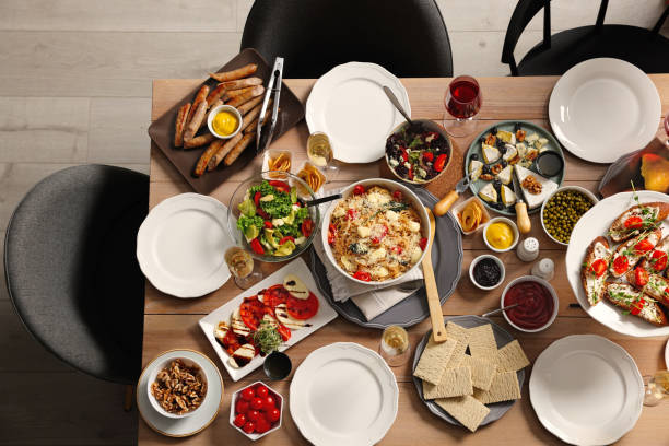 istock Brunch table setting with different delicious food and chairs indoors, top view 1453970400