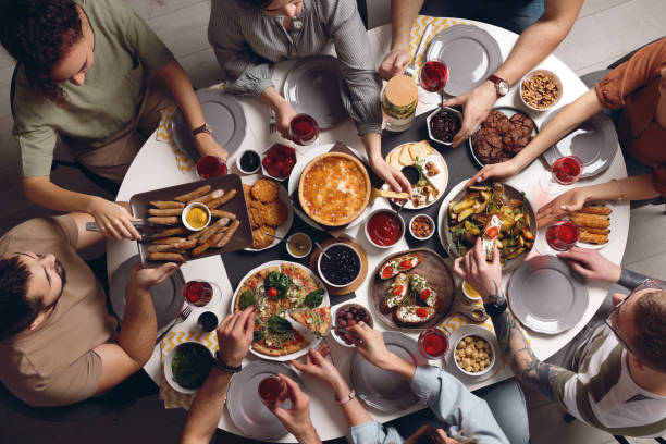 istock Group of people having brunch together at table indoors, top view 1453970641