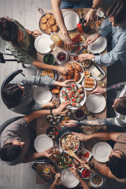 istock Group of people having brunch together at table indoors, top view 1453970749