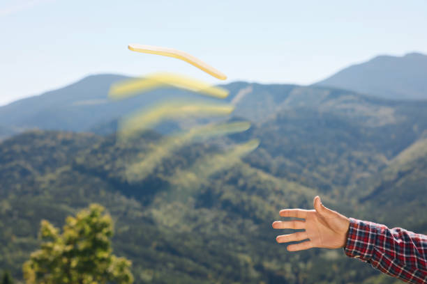 istock Man throwing boomerang in mountains, closeup view 1453971099
