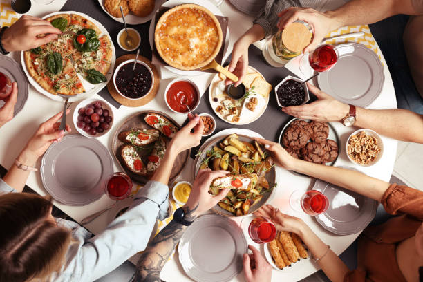 istock Group of people having brunch together at table indoors, top view 1453971125