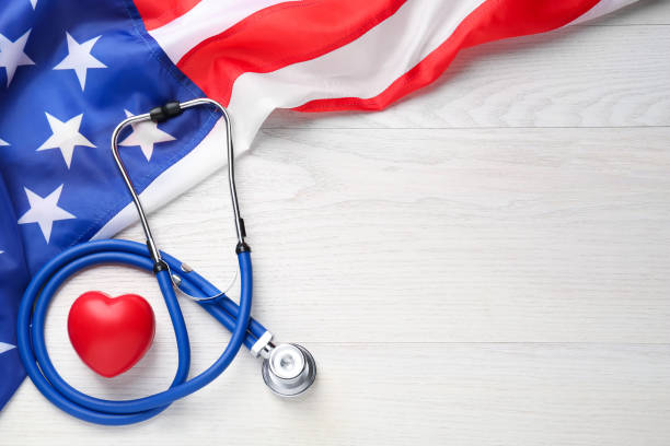istock American flag, heart and stethoscope on white wooden table, flat lay. Space for text 1453971884
