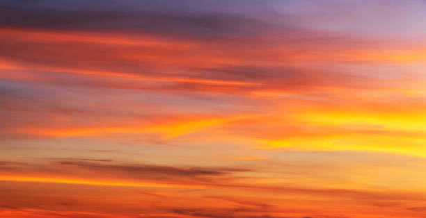 istock sky with gentle colorful clouds. Panoramic view of real sunset orange sunset 1453971888