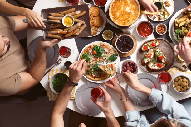 istock Group of people having brunch together at table indoors, top view 1453971950