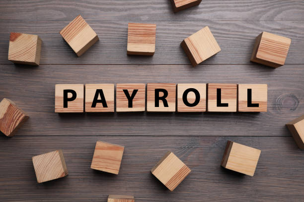istock Cubes with word Payroll on wooden table, flat lay 1453972028