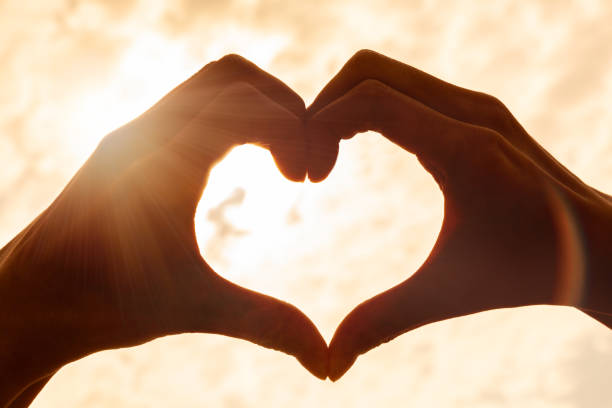 istock Hand Heart Sunrise Sunset 1453972054