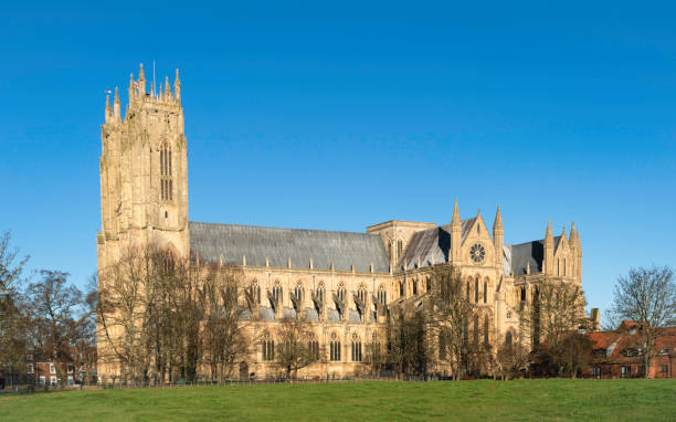 istock The ancient minster flanked by trees under blue clouds in summer. Beverley, UK. 1453972221