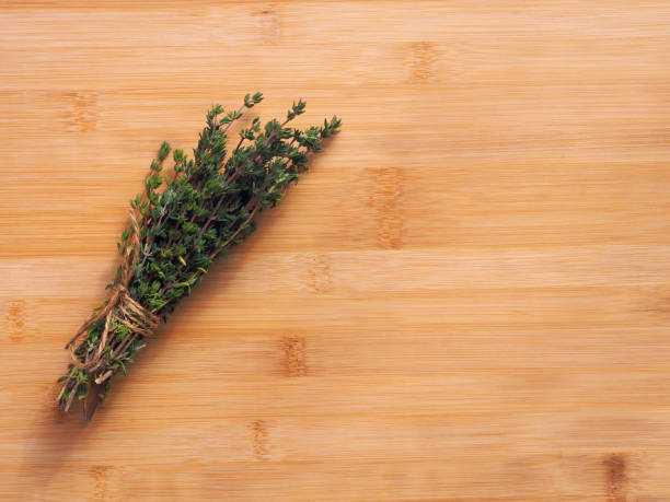istock Bundle of fresh thymes on a wooden background 1453972293