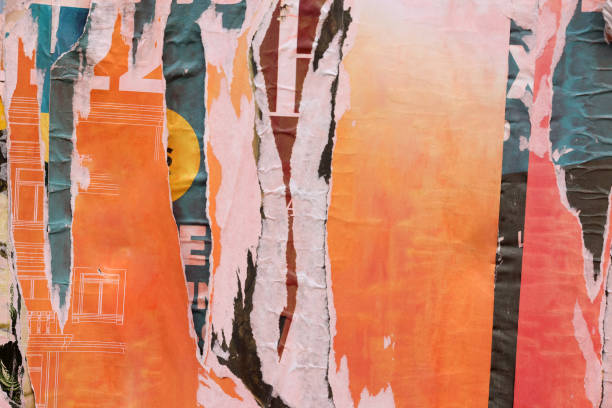 Pieces of torn paper peeling off wall used as billboard