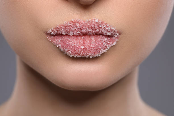 istock Woman with beautiful lips covered in sugar on background, closeup 1453972692