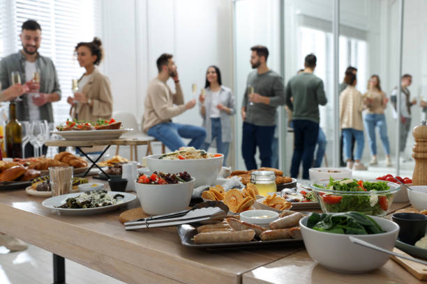 Brunch table setting with different delicious foodand blurred view of people on background