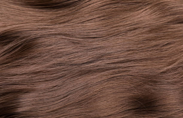istock Beautiful brown hair as background, top view 1453973625