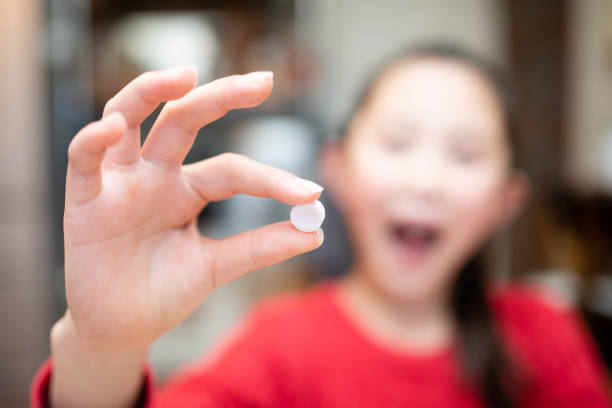 istock Child with sweets like pills 1453974032