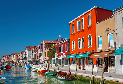 Murano island canal, colorful houses and boats, Venice, Italy