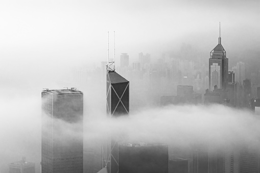 Skyscraper in downtown district of Hong Kong city in fog