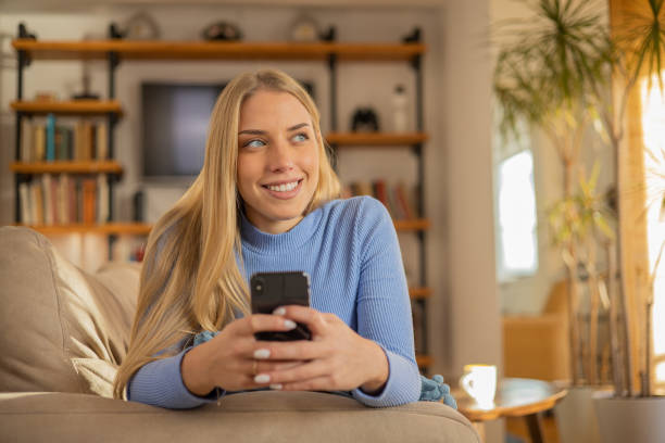istock Happy young woman using phone 1453983412