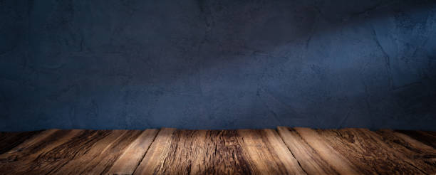 istock Wooden table or counter top with black stone wall background 1453984050