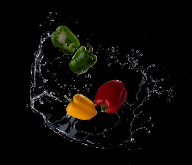 istock Water splash on sweet pepper isolated on black 1453985613