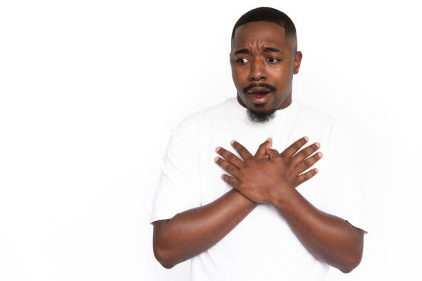 istock Shocked African American man pressing hands to chest 1453985648