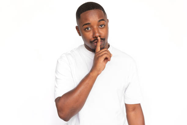 istock Serious African American man shushing 1453985745