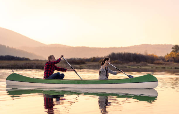 Travelers in canoes on Lake Cerkniško Excursionists enjoy and have fun exploring Cerkni Lake in good weather and at sunset. cerknica lake stock pictures, royalty-free photos & images