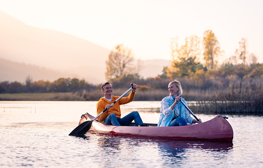 Excursionists enjoy and have fun exploring Cerkni Lake in good weather and at sunset.