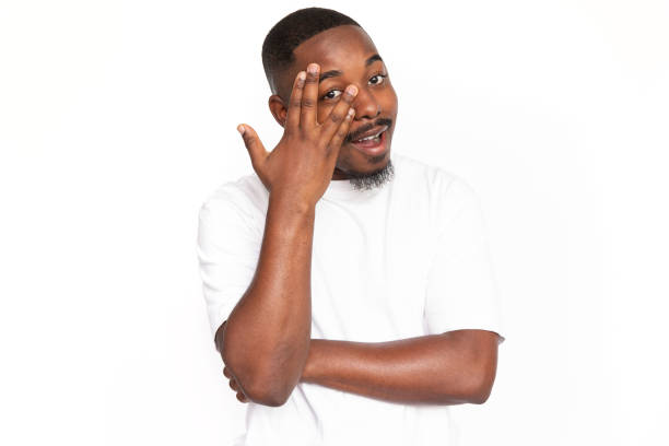 istock Happy African American man peeking between fingers 1453987028