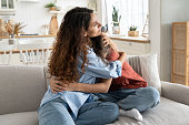 Loving mother comforting hugging unhappy teenage daughter, mom supporting depressed teen girl child