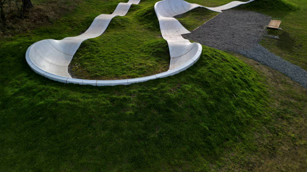 istock Skateboard park with concrete cement surface with concrete skateboard obstacles is designed for roller sports. Cycling is not allowed except for freestyle bikes.  winter morning sunrise, above, high 1453989421