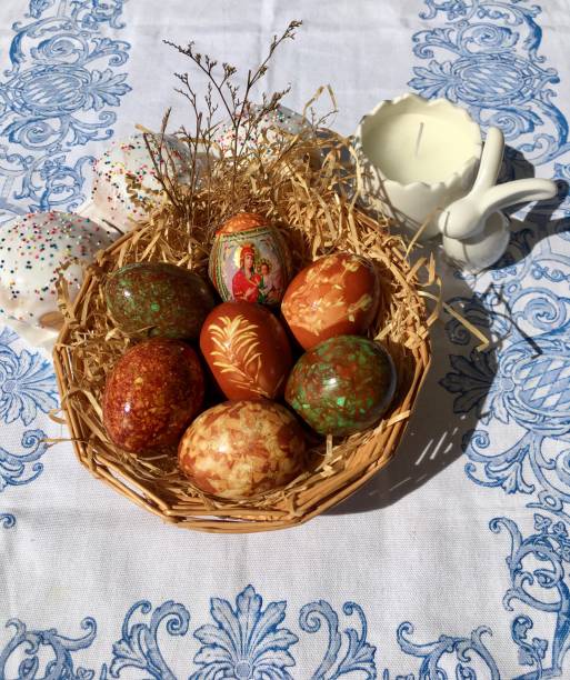 istock Yellow daffodils for Easter. Decoration for Easter. An interesting method of coloring eggs for Easter. Easter basket with colored eggs. Celebration of the religious holiday Easter in Europe. 1453990856