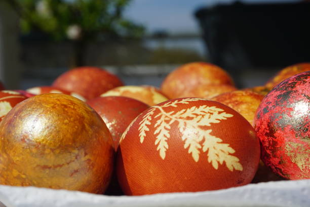 istock Yellow daffodils for Easter. Decoration for Easter. An interesting method of coloring eggs for Easter. Easter basket with colored eggs. Celebration of the religious holiday Easter in Europe. 1453991042
