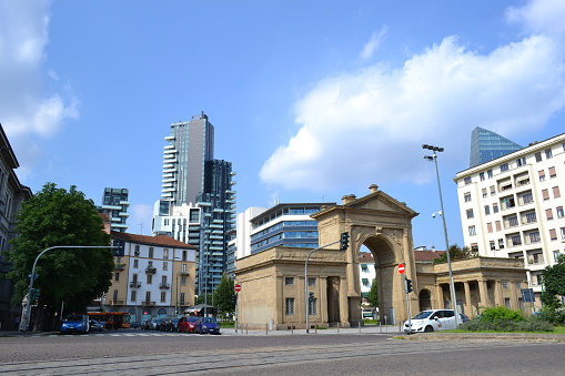 Panoramic view of the gate of Milan - the Porta Nuova - a triumphal arch in yellow sandstone in neoclassical style with the small porticoes and two toll booths in princess Clotilde square.
