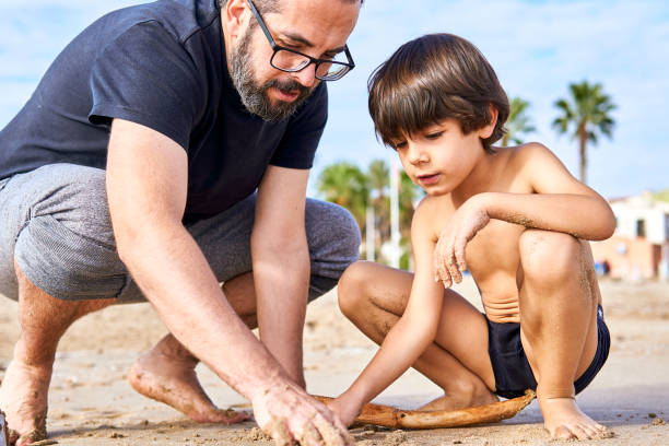 istock middle age father and son on the beach 1453992886