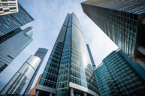 Modern office buildings at sunny day with clear blue sky, looking up