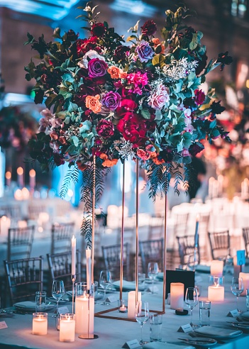 Beautiful flowers on the table with many candles - wedding interior