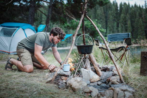 istock Man on camping vacation making the campfire. 1453993566