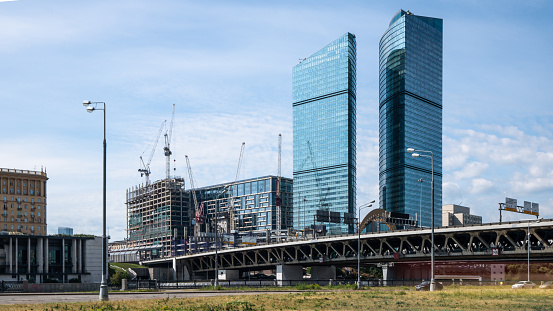 Development of new modern office buildings at sunny day with clear blue sky, looking up