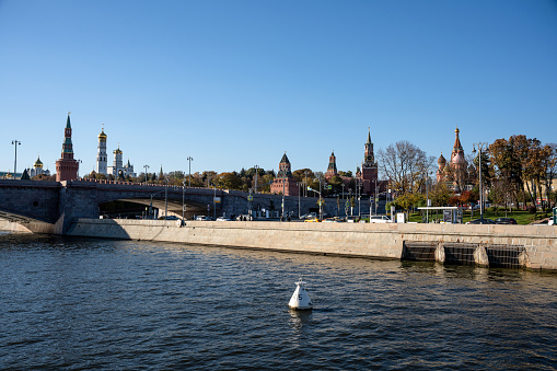 Illuminated Moscow Kremlin and Moscow river in winter morning. Pinkish and golden sky with clouds. Russia