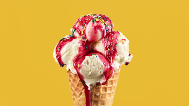 Ice cream of various colors changing at yellow background. Stop motion ice cream