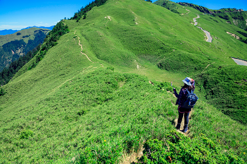 Woman is enjoying hiking on the Hehuan mountain in Taiwan.