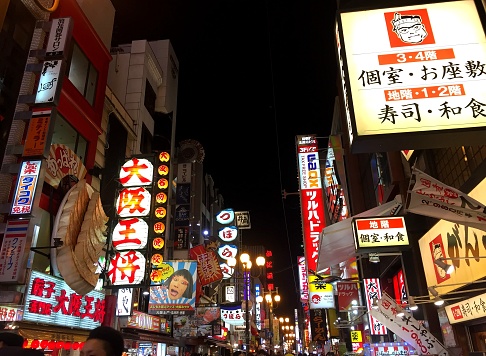 Osaka, February 2018: Illuminated signboards on Dotonbori, a popular tourist destination in Osaka, featuring a large variation of shops, street food and nightlife.