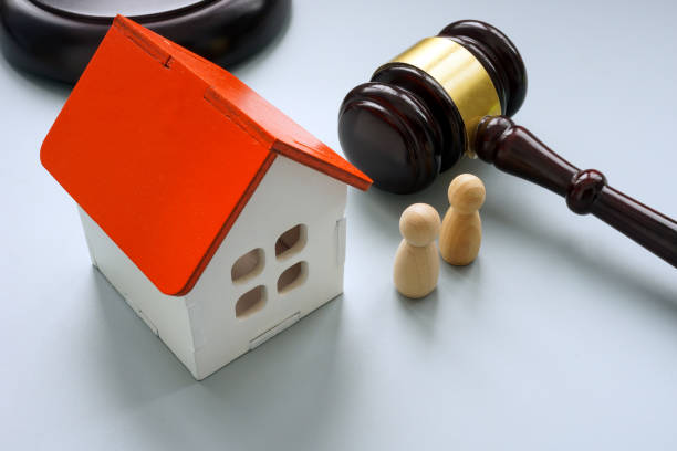 istock Model of house with two figures and gavel. Separation or inheritance concept. 1453997154