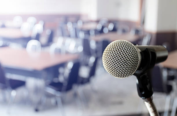 istock Close up microphone with tripod on stage in seminar room. 1453998283