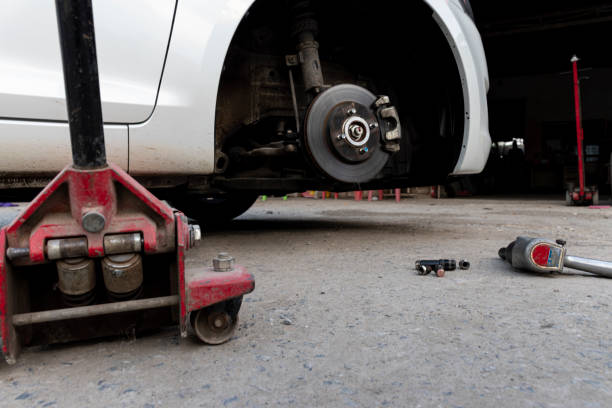 istock White cars change wheels using a lifting jack. 1453999203