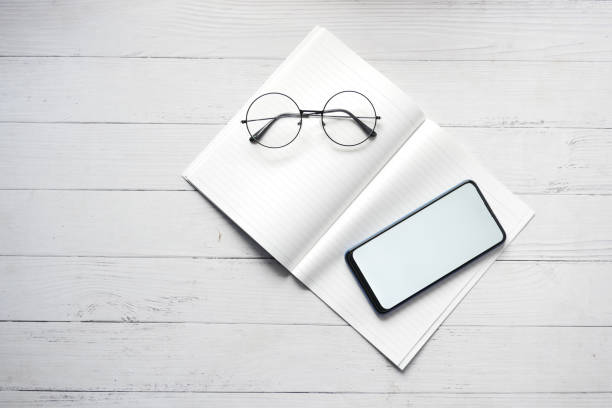 istock top view of smart phone and notepad on table 1454000559