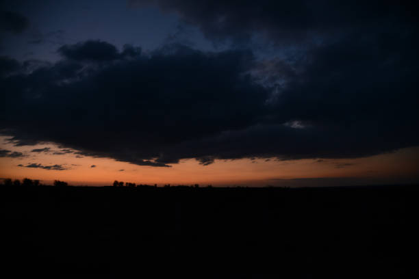 A scenic sunset over a field with trees