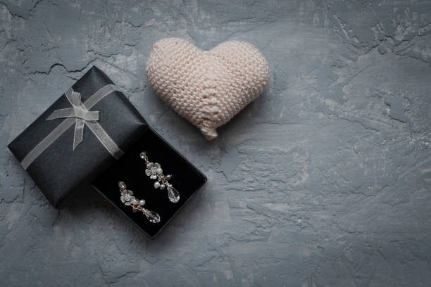 Earring in gift box with ribbon