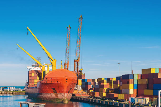 istock Dock cranes at seaport loading containers to container cargo freight ship in Batumi. Global trade 1454006223